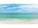 Wide expanse of clear turquoise ocean water meeting the sandy beach at 1211 Gulf Of Mexico Dr # 309, Longboat Key, FL 34228