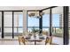 Modern dining room with floor-to-ceiling windows and ocean views at 1211 Gulf Of Mexico Dr # 309, Longboat Key, FL 34228