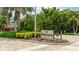 Community entrance sign featuring lush landscaping and clear signage for The Promenade at 1211 Gulf Of Mexico Dr # 309, Longboat Key, FL 34228
