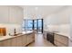 Bright modern kitchen with white countertops, stainless steel appliances and a view of the ocean at 1211 Gulf Of Mexico Dr # 309, Longboat Key, FL 34228