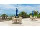 Ocean view patio area with comfortable seating arrangements and sun umbrellas at 1211 Gulf Of Mexico Dr # 309, Longboat Key, FL 34228
