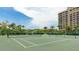 Well-maintained community tennis courts surrounded by lush tropical landscaping at 1211 Gulf Of Mexico Dr # 309, Longboat Key, FL 34228