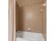 Cozy bathroom featuring a white bathtub with shower and tiled walls at 1268 11Th St # 2402, Sarasota, FL 34236