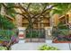 Inviting building entrance with secure gated entry and lush tropical landscaping at 1268 11Th St # 2402, Sarasota, FL 34236