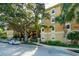 The exterior of the home features a tan stucco facade complemented by lush trees and landscaping at 1268 11Th St # 2402, Sarasota, FL 34236