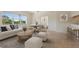 Bright living room with a large window, neutral decor, and seamless access to a dining area and a bedroom at 1268 11Th St # 2402, Sarasota, FL 34236