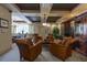 Cozy living room with plush leather chairs, a TV, and a game table for comfortable recreation and relaxation at 1268 11Th St # 2402, Sarasota, FL 34236