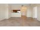 Open-concept living space with neutral tile flooring and a partial view of the kitchen area at 1268 11Th St # 2402, Sarasota, FL 34236