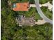An aerial view shows lush landscaping surrounding properties on a curved street at 13 Bayhead Ln, Osprey, FL 34229