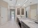 Bathroom with double vanity with granite countertop and bright lighting at 13 Bayhead Ln, Osprey, FL 34229