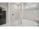 Luxurious bathroom featuring soaking tub, walk-in shower, and bright tile at 13 Bayhead Ln, Osprey, FL 34229