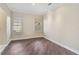 Spacious bedroom with wood floors and two windows provides natural light and ample space at 13 Bayhead Ln, Osprey, FL 34229