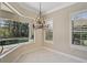 Bright breakfast nook with bay window overlooking the pool and lush landscaping offers style at 13 Bayhead Ln, Osprey, FL 34229