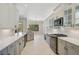 Beautiful open kitchen boasts white countertops and cabinetry with stainless steel appliances at 13 Bayhead Ln, Osprey, FL 34229