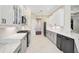 Modern kitchen features sleek appliances, white countertops, cabinetry, and tile floors at 13 Bayhead Ln, Osprey, FL 34229
