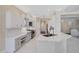 Bright kitchen with white marble countertops, tiled floors, and modern appliances offers great flow at 13 Bayhead Ln, Osprey, FL 34229