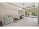Cozy living room area with tile floors and view of screened-in outdoor space at 13 Bayhead Ln, Osprey, FL 34229