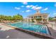 A beautiful swimming pool with lounge chairs and a clubhouse in the background at 13 Bayhead Ln, Osprey, FL 34229