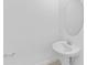 Elegant powder room with a pedestal sink, faucet and round mirror at 14783 Lyla Ter, Bradenton, FL 34211