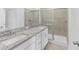 Modern bathroom features double vanity with granite counters and walk-in shower at 14783 Lyla Ter, Bradenton, FL 34211