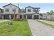 Inviting townhome boasts a well-manicured lawn, long driveway, and an attached garage at 14783 Lyla Ter, Bradenton, FL 34211