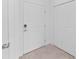 Neutral hallway with white door, closet, and tan tile flooring, showcasing a clean design at 14783 Lyla Ter, Bradenton, FL 34211