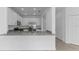 Open kitchen features stainless steel appliances, white cabinets, and bright neutral color scheme at 14783 Lyla Ter, Bradenton, FL 34211