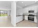 Bright, white kitchen with stainless steel appliances and a view of the pond and backyard at 14783 Lyla Ter, Bradenton, FL 34211