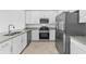 Modern kitchen featuring stainless steel appliances, white cabinets, and stylish countertops at 14783 Lyla Ter, Bradenton, FL 34211