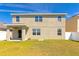 The back exterior showcases a two-story design with a covered patio and well-maintained lawn at 15118 Agave Grove Pl, Bradenton, FL 34212