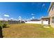Spacious backyard with a tranquil pond view, white fencing, and access to the home's exterior at 15118 Agave Grove Pl, Bradenton, FL 34212