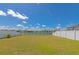 Large backyard featuring a well-manicured lawn and a picturesque view of the tranquil water at 15118 Agave Grove Pl, Bradenton, FL 34212