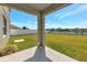 Inviting backyard with a spacious patio, lush green grass, and a tranquil water view at 15118 Agave Grove Pl, Bradenton, FL 34212