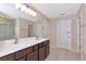Bathroom with glass shower, double sink vanity with modern fixtures and tiled floor at 15118 Agave Grove Pl, Bradenton, FL 34212