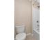 Bathroom showcasing a white toilet next to a shower with white tiling for a clean look at 15118 Agave Grove Pl, Bradenton, FL 34212