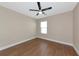 Comfortable bedroom with ceiling fan and wood-look flooring at 15118 Agave Grove Pl, Bradenton, FL 34212