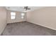 Bedroom featuring neutral walls, plush carpet, and natural light from two windows at 15118 Agave Grove Pl, Bradenton, FL 34212