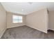 Bright bedroom featuring plush carpeting and a window allowing natural light to fill the space at 15118 Agave Grove Pl, Bradenton, FL 34212