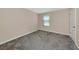 Bedroom featuring neutral walls, plush carpet, and natural light from window at 15118 Agave Grove Pl, Bradenton, FL 34212