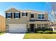 Charming two-story home with a well-maintained lawn and a two-car garage at 15118 Agave Grove Pl, Bradenton, FL 34212