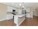 Modern kitchen with white cabinets, stainless steel appliances, and a stylish center island at 15118 Agave Grove Pl, Bradenton, FL 34212