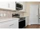Close-up of the kitchen featuring a stainless steel oven and mosaic backsplash at 15118 Agave Grove Pl, Bradenton, FL 34212