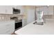 Close-up of a modern kitchen with quartz countertops and stainless steel appliances at 15118 Agave Grove Pl, Bradenton, FL 34212