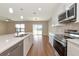 Modern kitchen with an island, stainless steel appliances, and sliding glass doors at 15118 Agave Grove Pl, Bradenton, FL 34212