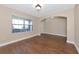 Bright living room featuring wood-look floors and large window with blinds at 15118 Agave Grove Pl, Bradenton, FL 34212