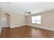 Spacious living room with wood-look floors, ceiling fan, and lots of natural light at 15118 Agave Grove Pl, Bradenton, FL 34212