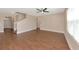Open-concept living space with wood-look floors, staircase, and natural light at 15118 Agave Grove Pl, Bradenton, FL 34212