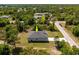 An aerial view showcasing the roof and the surrounding green landscape and a peek into the neighborhood at 158 Chickering St, Port Charlotte, FL 33954