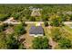 An aerial view of the home, showcasing its location surrounded by lush greenery and trees at 158 Chickering St, Port Charlotte, FL 33954