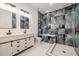 Stylishly designed bathroom with double vanity and shower featuring unique stone look tile at 158 Chickering St, Port Charlotte, FL 33954